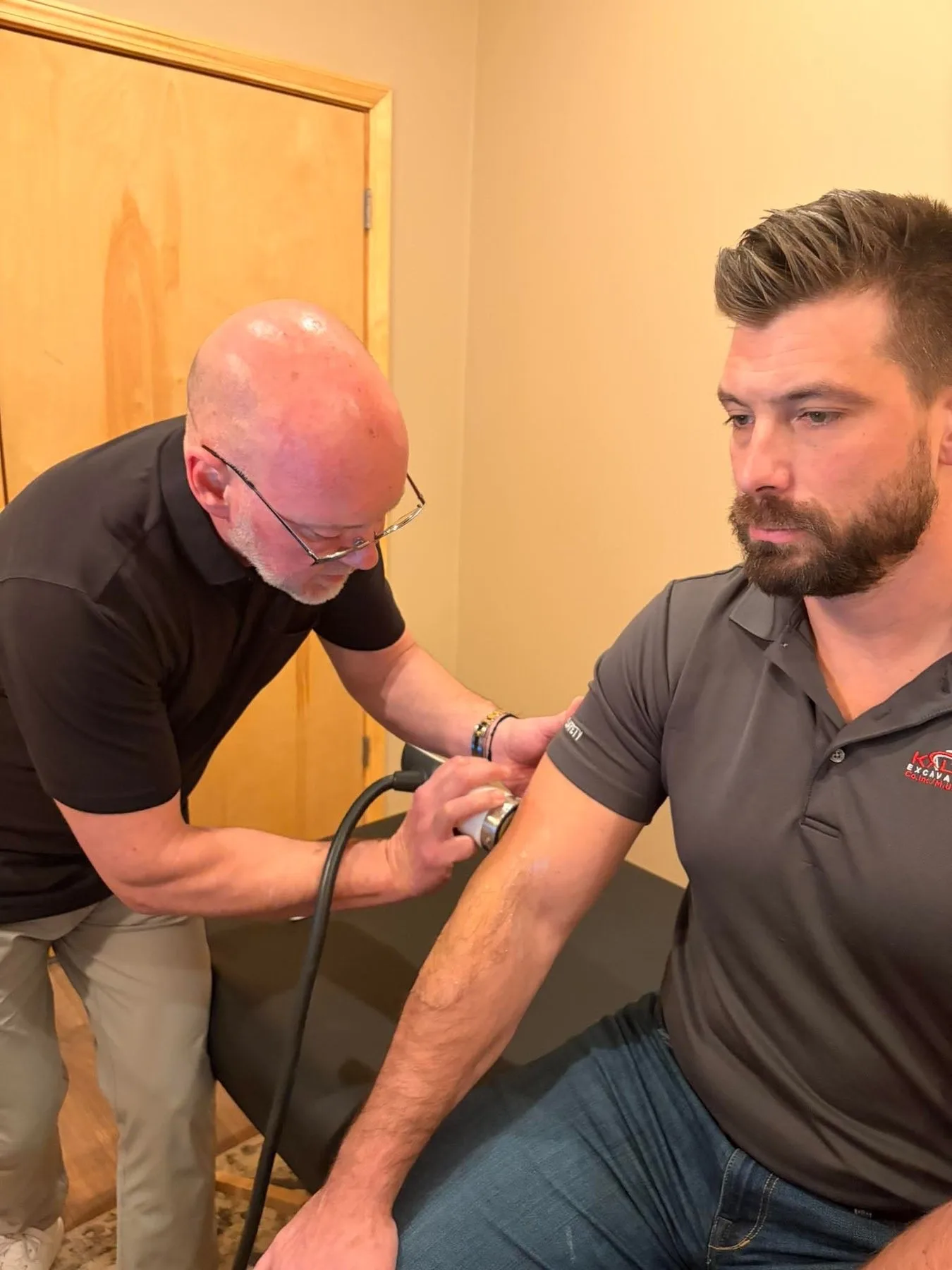 Dr. Ed McCuiston working with a patient's arm and shoulder mobility
