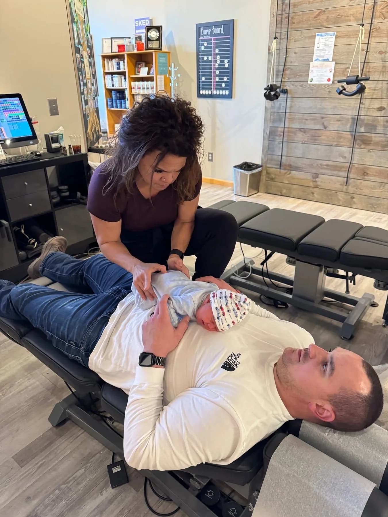 Dr. Sandie McCuiston providing infant chiropractic care with a parent nearby