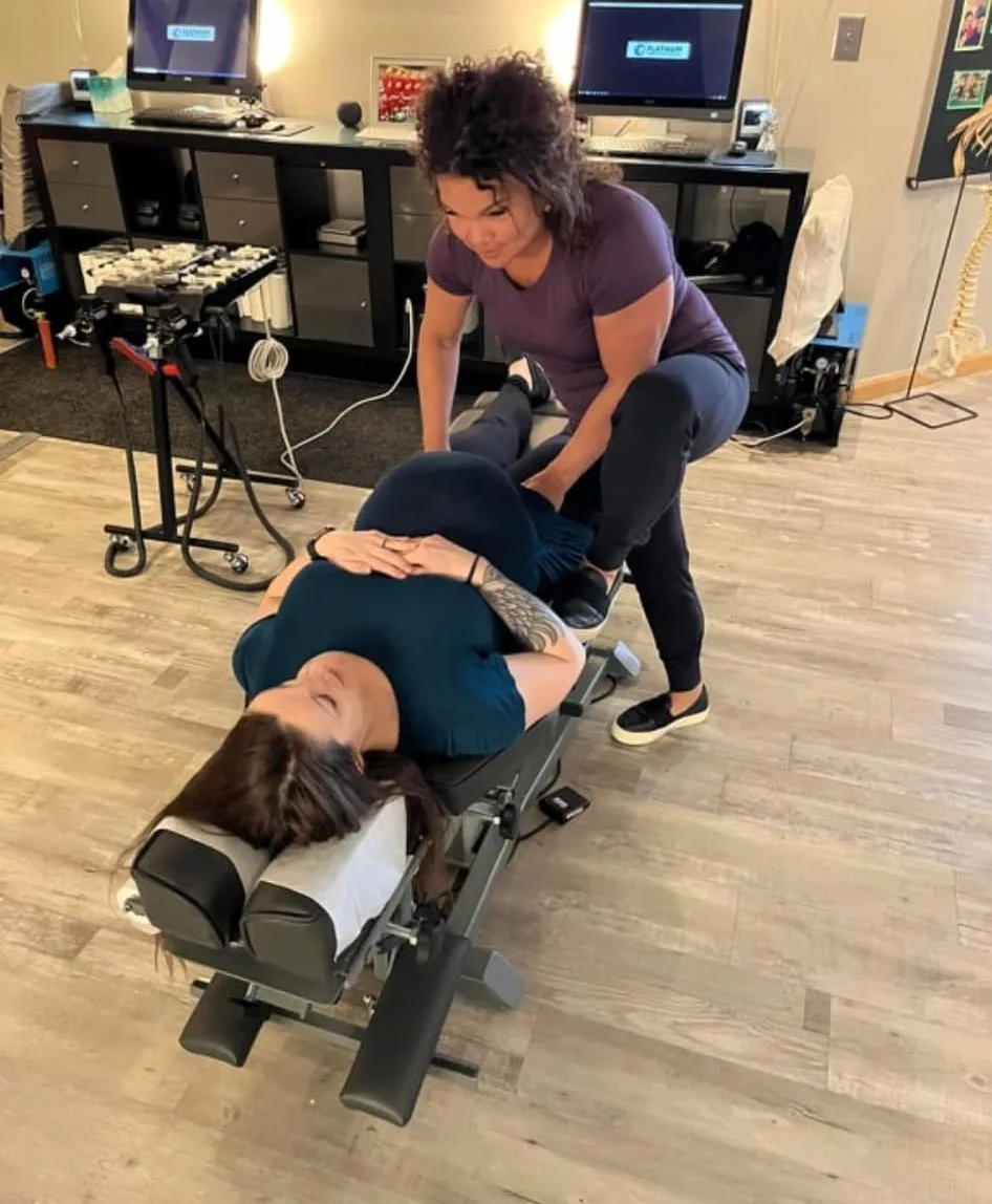 Dr. Sandie McCuiston adjusting an adult patient at Touch of Life Chiropractic
